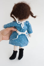 primitive doll with brown pigtails